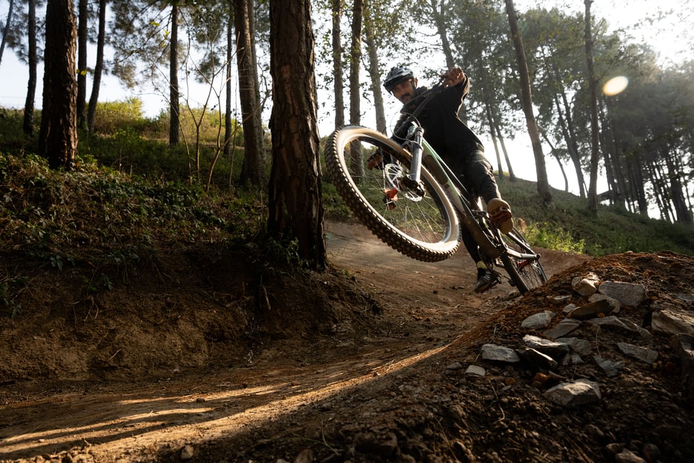 Tejson Kunwar glides through the edge of a berm in the Bhanjyang Trail. All photos: LUJA MANANDHAR