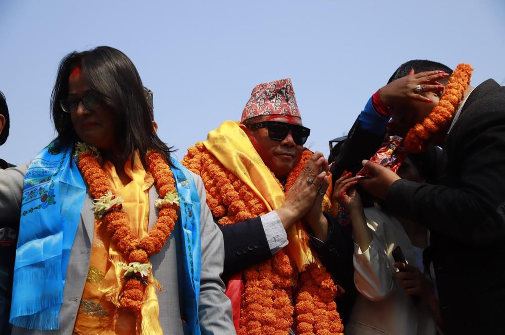 Resham Chaudhary waves to supporters after being released from prison.