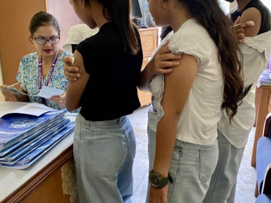 Girls wait for their vaccination cards to be updated after receiving the HPV vaccine at BP Koirala Cancer Hospital in Bharatpur. Photos: MARTY LOGAN