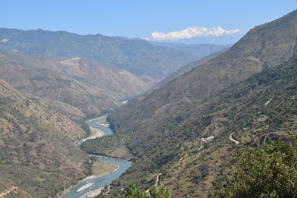 The glacier-led Tamor River originates below Kangchenjunga seen here on the horizon, and flows below fields waiting for rain. Photo: MOHAN MAINALI