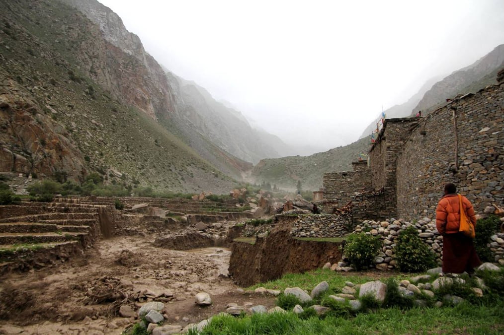 SAME STORY: A monk looks at an approaching glacial lake outburst flood in Halji of Humla's Limi Valley in 2011 that destroyed the monastery. The flood was caused by a hidden glacial lake in the mountains above much like what happened in Thame last week. Photos: ASTRID HOVDEN