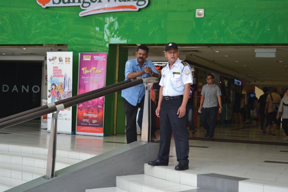 A Nepali security guard at a department store in Kuala Lumpur. Photo: OM ASTHA RAI / NEPALI TIMES ARCHIVES
