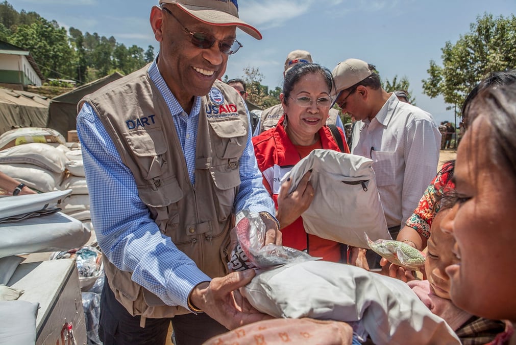 HANDSHAKE: USAID officials distributing baby packs and hygiene kits to survivors of the 2015 earthquake in Sindupalchok. Photo: USAID