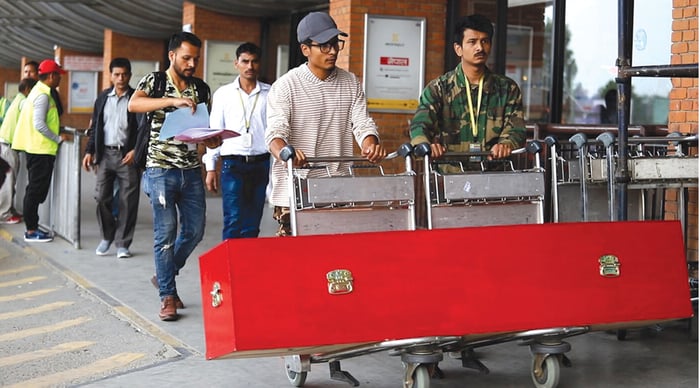 Qatar urged to pay families of dead workers